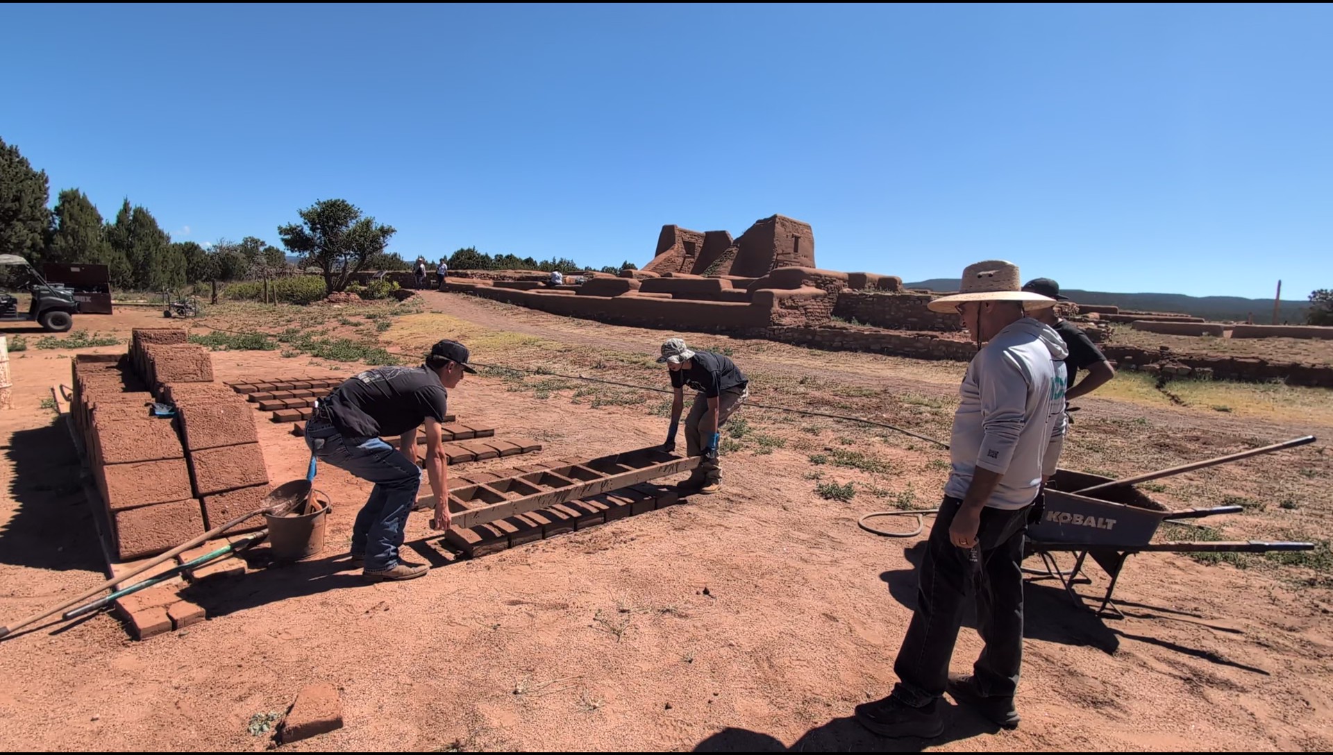 Mud capping and adobe brick making by work interns at Pecos National Historical Park summer 2026